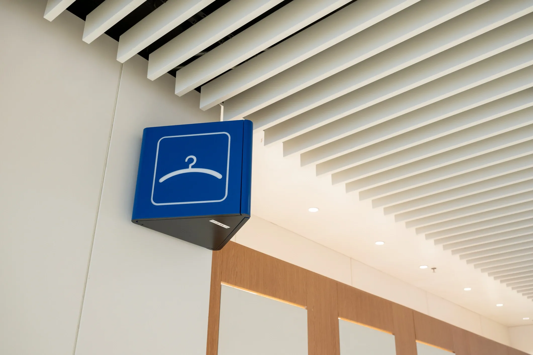 Blue fitting room sign in modern store.